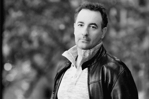 A black and white modern headshot of a white man