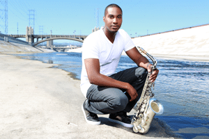 A modern image of a man with a white shirt and jeans holding a silver sax