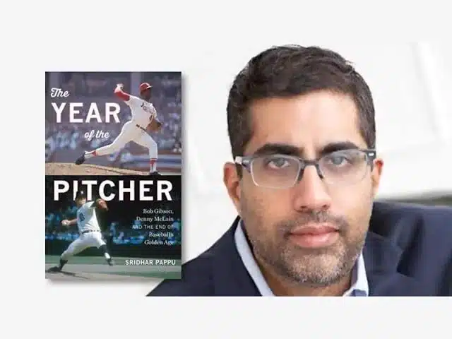 A book titled The Year of the Pitcher featuring a baseball player in action on the cover is next to a person wearing glasses and a suit, with a thoughtful expression. The background is light gray.