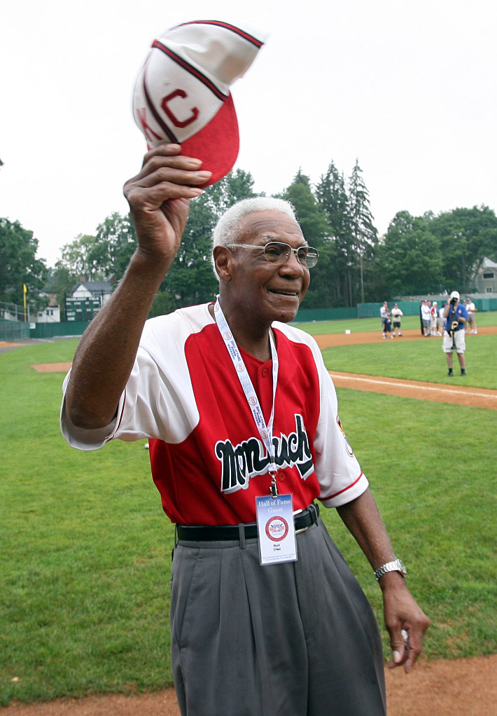 Old Negros League member Buck O'Neil cheers as he watches Baseball Hall of Famer Ozzie Smith turn a double play at Doubleday Field in Coooperstown, NY on July 28, 2006. O'Neil is on hand for the induction of former St. Louis Cardinals pitcher Bruce Sutter and 17 others that were involved with the Negro Leagues. (UPI Photo/Bill Greenblatt)
