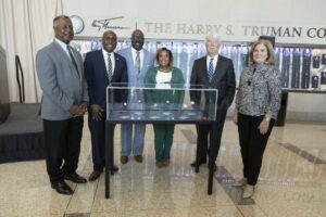 A group of distinguished folks around the display case of the NLB Commemorative Coins