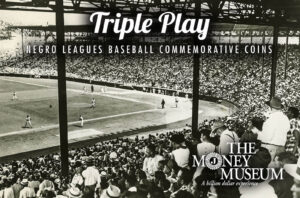 A black-and-white photo of a crowded baseball stadium during a game. The text reads Triple Play: Negro Leagues Baseball Commemorative Coins. The Money Museum logo is visible in the bottom right corner.