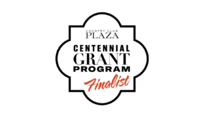 Logo of the Country Club Plaza Centennial Grant Program with the text Finalist in a stylized design. The emblem is shaped in an ornate border with bold black and red lettering.