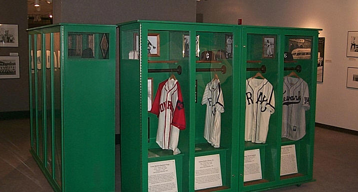 Shot of green lockers with baseball jerseys for the Discover Greatness exhibit