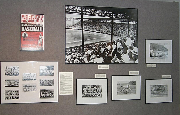 framed images and info cards on a wall for the Discover Greatness exhibit