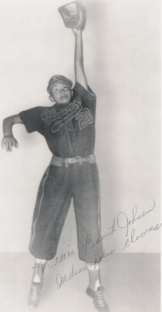 Black and White Photo of Mamie Johnson jumping up to catch the ball