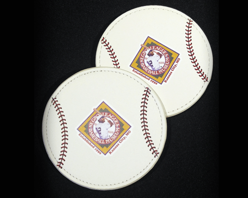 Two circular leather patches resembling baseballs, featuring the Negro Leagues Baseball Museum logo in the center on a black background.