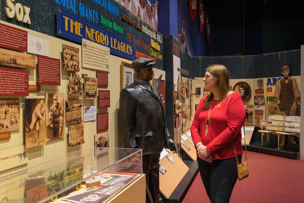 Woman in a red sweater looking at the NLBM exhibit